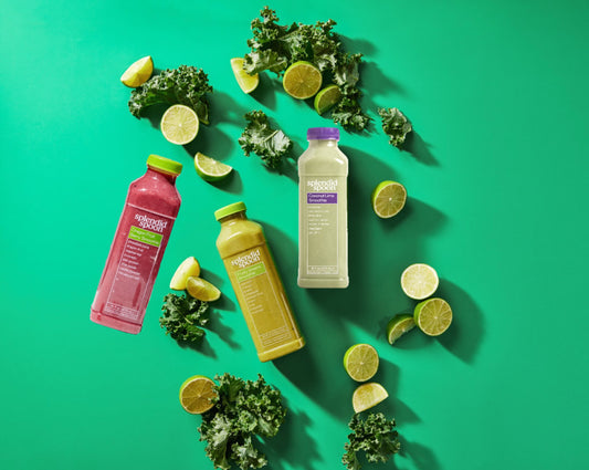 3 splendid spoon smoothies on a green background with kale and limes